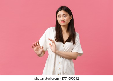 Beauty, people emotions and summer leisure and vacation concept. Reluctant and displeased asian woman feeling uncomfortable, rejecting offer, step back and grimacing from dislike awkward