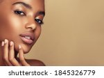 Beauty portrait of African American girl . Beautiful black woman touch her face . Facial  treatment . Cosmetology , skin care  and spa . 