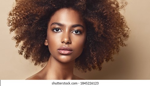Beauty portrait of african american girl with clean healthy skin   Beautiful and serious black woman.Curly afro hair