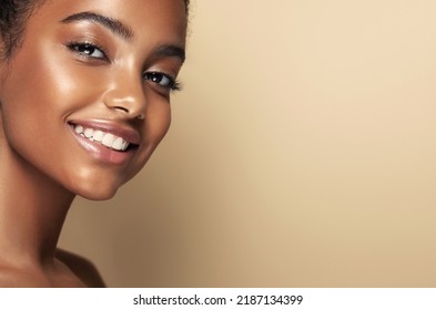 Beauty Portrait Of African American Girl . Beautiful Black Woman With Sincere White-toothed Smile  . Facial  Treatment . Cosmetology , Skin Care  And Spa . 