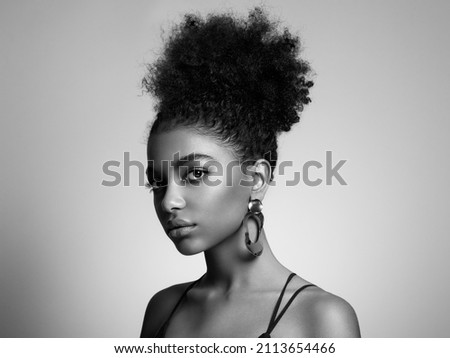 Beauty portrait of African American girl with afro hair. Beautiful black woman. Cosmetics, makeup and fashion