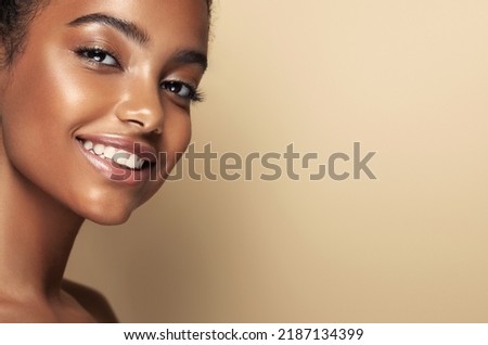 Beauty portrait of African American girl . Beautiful black woman with sincere white-toothed smile  . Facial  treatment . Cosmetology , skin care  and spa . 