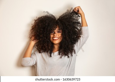 Beauty portrait of african american woman with afro hairstyle and glamour makeup. Brazilian woman. Mixed race. Curly hair. Hair style. White background.
