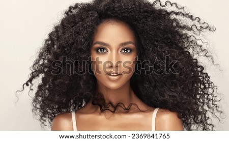 Beauty portrait of african american woman with wavy hairstyle . Smiling dreamy beautiful afro girl.Curly black hair