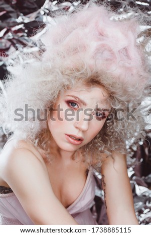 beauty portrait of a beautiful blonde with a magnificent hairstyle similar to marshmallows
