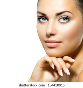 Beauty Portrait. Beautiful Spa Woman Touching her Face. Perfect Fresh Skin closeup. Isolated on White Background. Pure Beauty Model. Youth and Skin Care Concept 