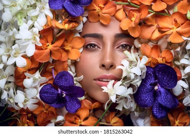 Beauty portrait. Beautiful woman with sensual lips lying among colored flowers. Cosmetics, make-up. Perfumery. - Shutterstock ID 1815263042