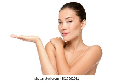 Beauty Portrait Of Beautiful Woman Showing Beauty Product / Empty Copy Space On Open Hand Palm. Mixed Race Asian / Caucasian Female Model Isolated On White Background.