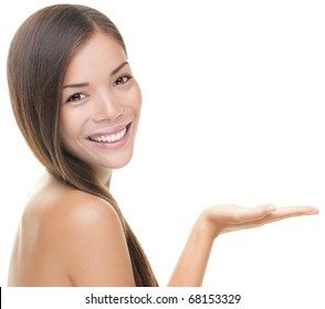 Beauty Portrait Of Beautiful Woman Showing Beauty Product / Empty Copy Space On Open Hand Palm. Mixed Race Asian / Caucasian Female Model Isolated On White Background.