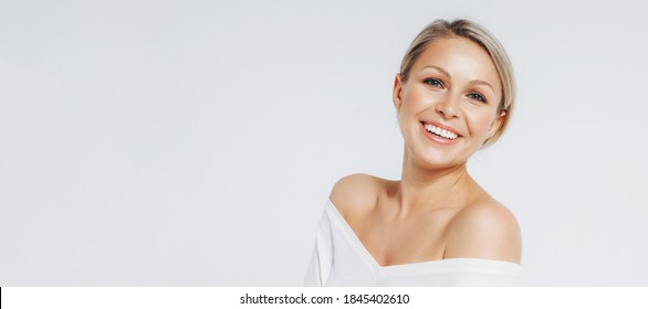 Beauty portrait of blonde smiling laughing woman 35 year clean fresh face isolated on white background, banner