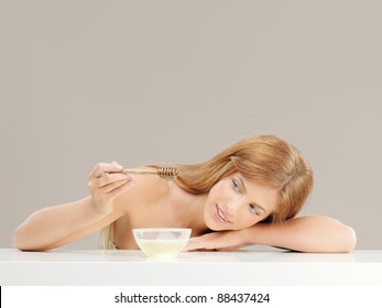 Beauty Portrait Of Blonde Woman With Honey Bowl, Smiling