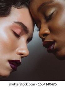 Beauty portrait close up of africans and europeans girls with  make up. Two beautiful girls of different races dark skinned and white skinned wit