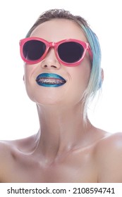 Beauty Portrait Of Fancy Caucasian Female With Silky Skin And Teeth Brackets Wearing Red Sunglasses As Dental Healthcare Ideas. Vertical Image