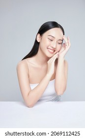 Beauty portrait of happy Asian female face with natural skin on white background