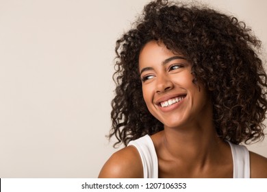 Beauty portrait of happy black woman on light background