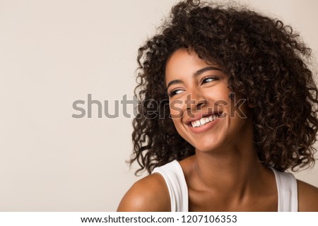 Beauty portrait of happy black woman on light background