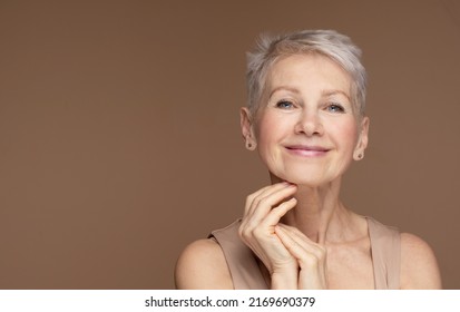 Beauty Portrait Of Mature Woman Smiling With Hand On Face. Closeup Face Of Happy Senior Woman Feeling Fresh After Anti-aging Treatment. Smiling Beauty Looking At Camera With Perfect Skin.