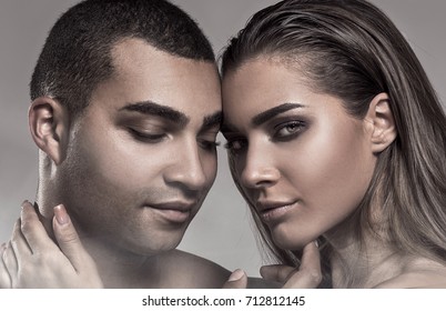 Beauty portrait of sensual beautiful couple. Caucasian woman with glamour makeup posing with handsome african american man.