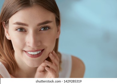 Beauty Portrait Of Smiling Woman With White Teeth Smile. Beautiful Happy Girl With Fresh Skin, Natural Face Makeup Indoors Closeup