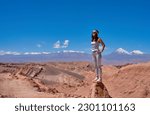 beauty portrait standing mid adult woman looking at the landscape in the valley of the moon in san pedro de atacama	