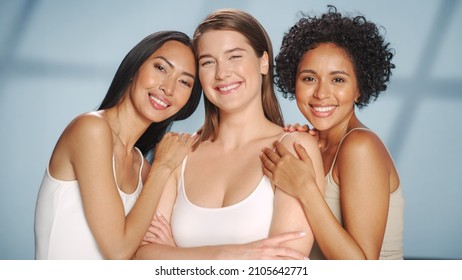 Beauty Portrait of Three Diverse Multiethnic Models on Isolated Background. Laughing Happy Asian, Black and Caucasian Women with Natural, Healthy Skin. Wellness, Spa, Cosmetology, Skincare Concept.