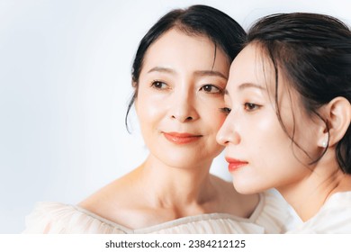 Beauty portrait of two Asian middle-aged women with skin care and cosmetics concept.