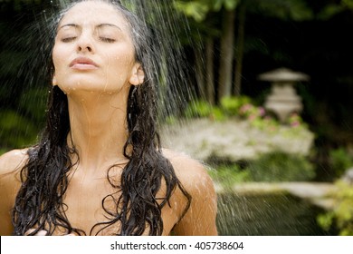 Beauty portrait of a woman in a tropical shower setting. - Powered by Shutterstock