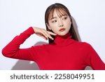 Beauty portrait of young Asian woman in red knit