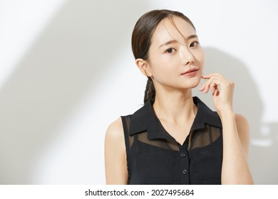 Beauty portrait of a young Asian woman in a black dress