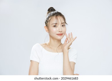 Beauty Portrait Of A Young Asian Woman With Bun Hair