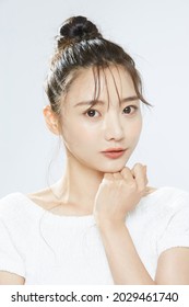 Beauty portrait of a young Asian woman with bun hair