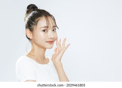 Beauty Portrait Of A Young Asian Woman With Bun Hair