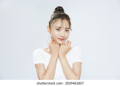 Beauty Portrait Of A Young Asian Woman With Bun Hair