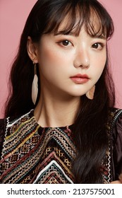Beauty portrait of young Asian woman with freckle makeup on pink background