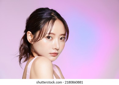 Beauty portrait of young Asian woman on colorful background