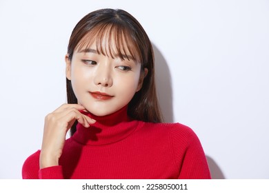 Beauty portrait of young Asian woman in red knit