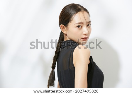 Beauty portrait of a young Asian woman in a black dress