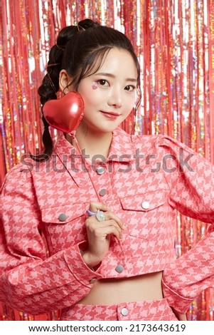 Beauty portrait of a young Asian woman with sticker makeup on glittery background