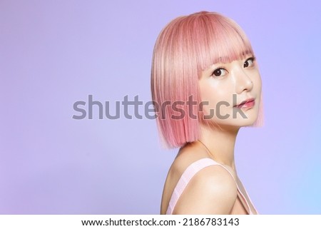 Beauty portrait of a young Asian woman with pink hair