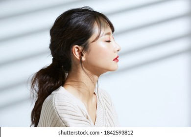 
Beauty portrait of young Asian women on light and shadow background - Shutterstock ID 1842593812