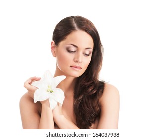 Beauty portrait of young, attractive, fresh, healthy and natural woman with the lily flower isolated on white