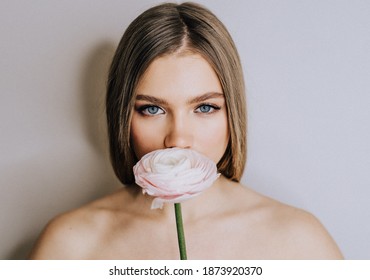 Beauty portrait of young woman with flower