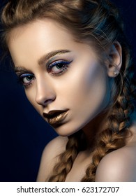 Beauty Portrait Of Young Woman With Modern Make Up. Perfect Skin And Fashion Makeup. Blue Eyeliner And Bronze Lipstick Studio Shot. Sensuality, Passion, Trendy Luxurious Makeup Concept.