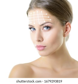 Beauty portrait of young woman with white lines on forehead for cosmetic medical procedures or plastic surgery. Skin care, anti-aging, lifting, rejuvenation concept