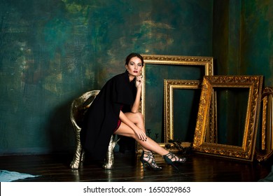 Beauty Rich Brunette Woman In Luxury Interior Near Empty Golden Frames, Lifestyle People Concept