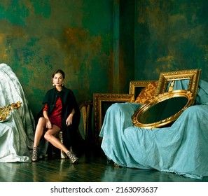 Beauty Rich Brunette Woman In Luxury Interior Near Empty Frames, Wearing Fashion Clothes, Lifestyle People Concept