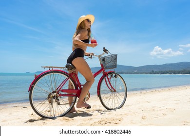 The Beauty Riding A Bicycle On The Beach At Sunset,the Stylish Girl By Her Bicycle, The Beach Cruiser Bicycle, A Road Bicycle Look Of Style,the Kind Stylish Woman In A Hat Sports,Thailand,island Samui