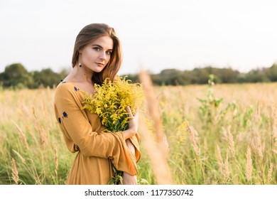 Beauty Romantic Girl Outdoors. Beautiful Teenage Model girl Dressed in Casual Short Dress on the Field in Sun Light. Blowing Long Hair. Autumn. Glow Sun, Sunshine. Backlit. Toned in warm colors - Powered by Shutterstock