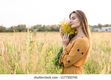 Beauty Romantic Girl Outdoors. Beautiful Teenage Model girl Dressed in Casual Short Dress on the Field in Sun Light. Blowing Long Hair. Autumn. Glow Sun, Sunshine. Backlit. Toned in warm colors - Powered by Shutterstock