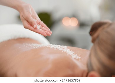 Beauty salon, back and hands with salt for massage with body scrub, exfoliating and cosmetic treatment. Skincare, wellness therapist and client for natural detox, glowing skin and dermatology at spa - Powered by Shutterstock